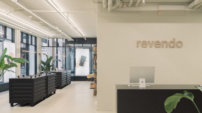 a large office with a plant in the middle of the room